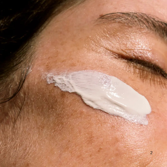Woman applying India Botanicals Barrier Repair Moisturiser for hydrated, supple skin.